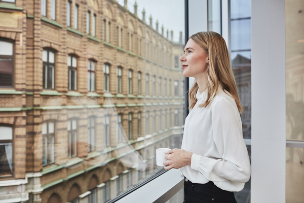 Woman standing by the window with cup Indoor air environment photo shoot session Aura