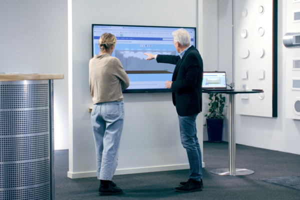 People watching a big TV screen in the showroom in Farum. One of them is explaining air diffusion on the screan with the help of smoke simulation in indoor climate designer / lindqst People watching a big TV screen in the showroom in Farum. One of them is explaining air diffusion on the screan with the help of smoke simulation in indoor climate designer / lindqst
